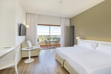 a room with two beds and a television