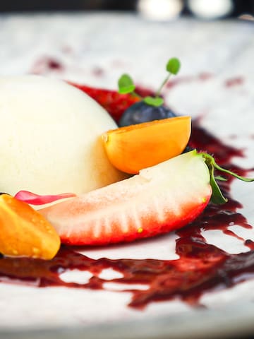 a plate of fruit and berry dessert