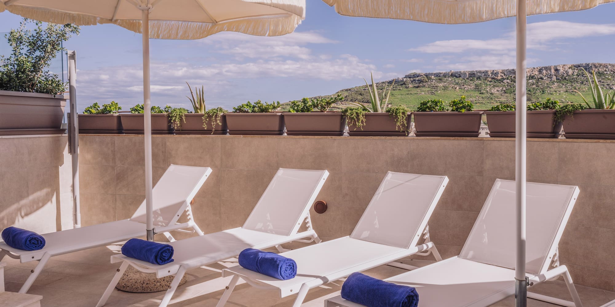 a group of chairs and umbrellas on a patio
