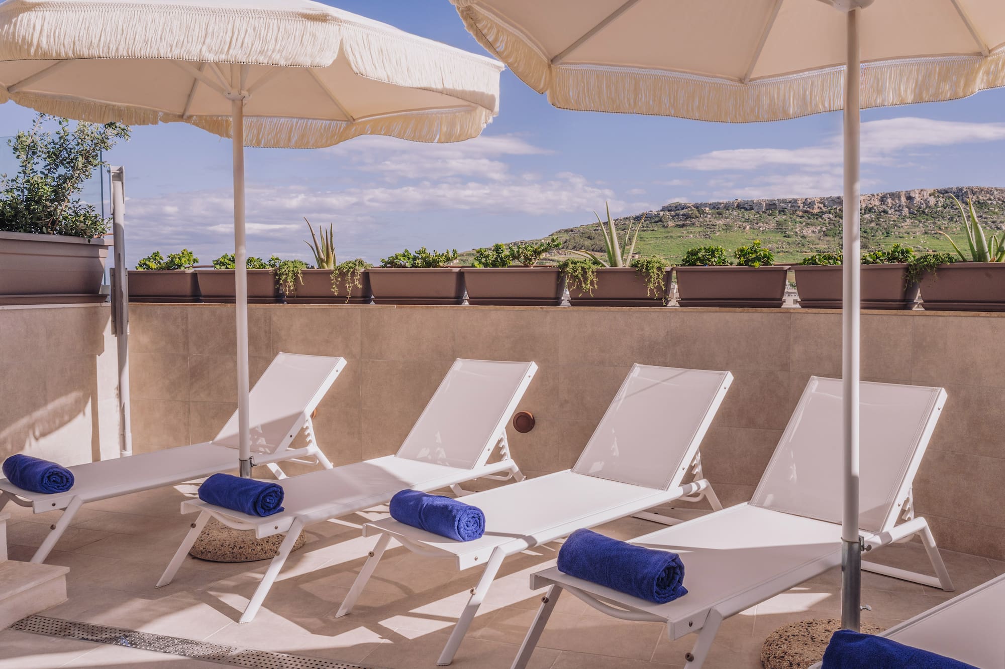 a group of chairs and umbrellas on a patio