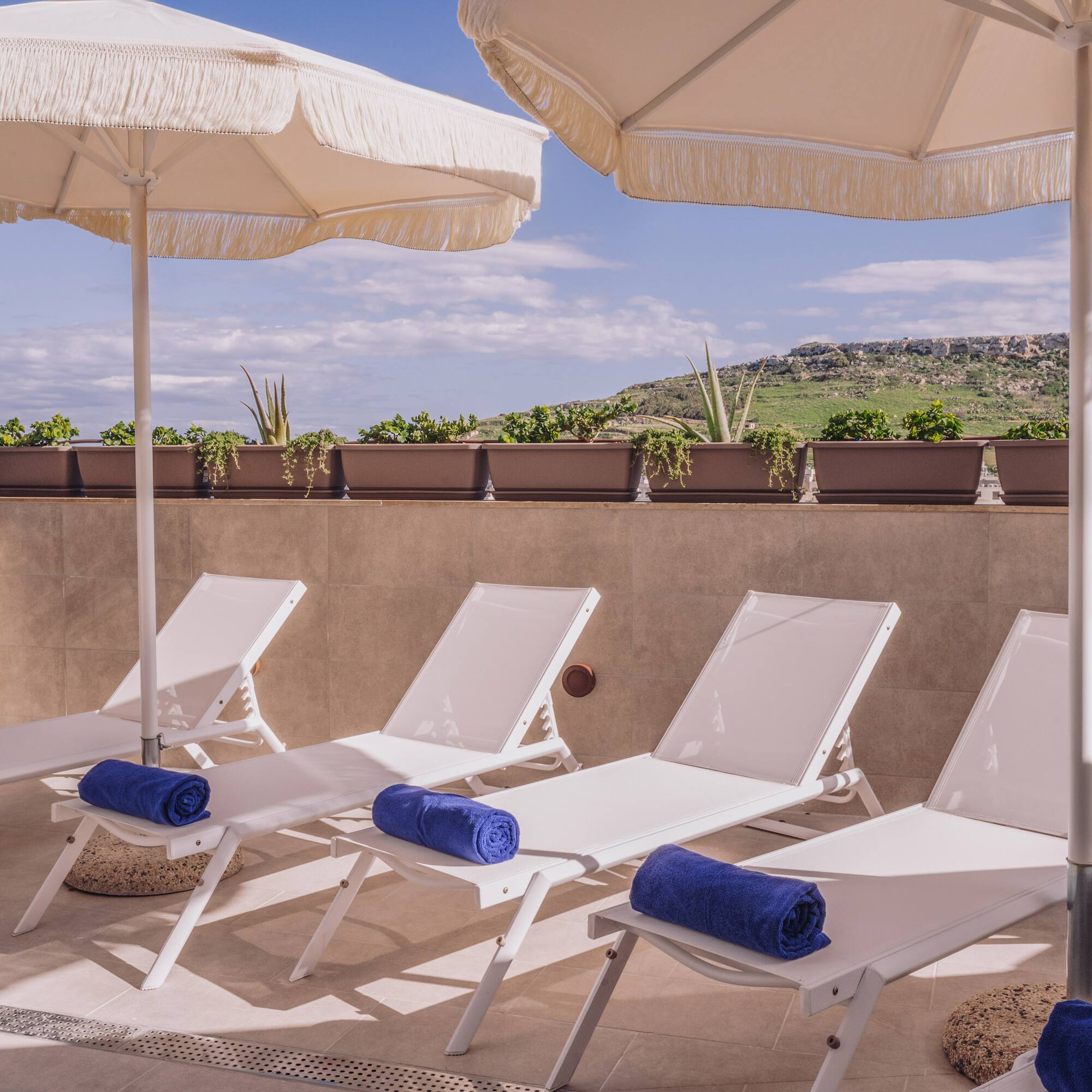 a group of chairs and umbrellas on a patio
