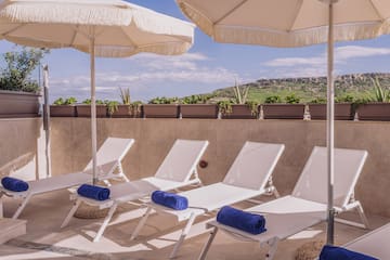 a group of chairs and umbrellas on a patio