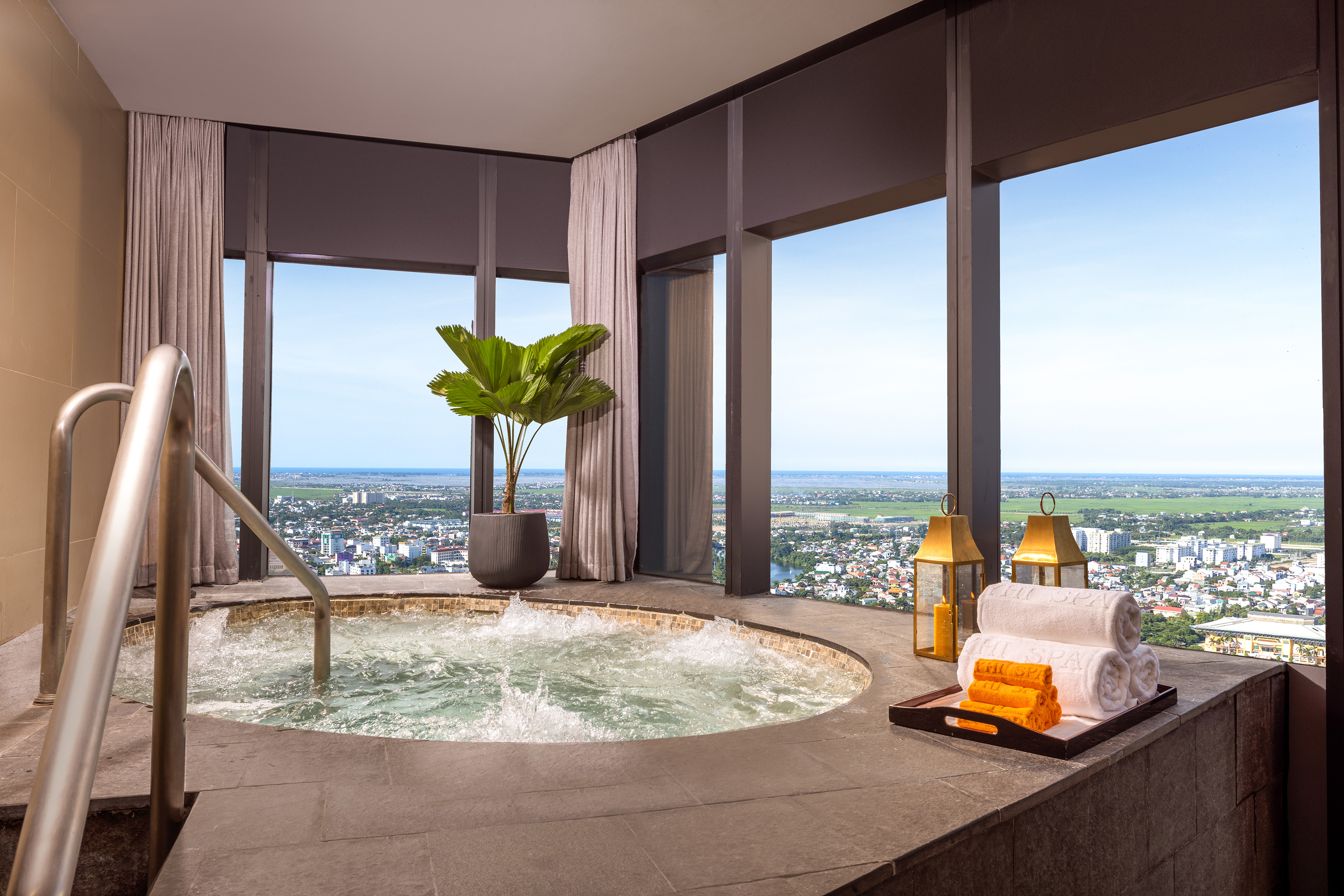 Bubbling jacuzzi with panoramic city view, luxury hotel spa.