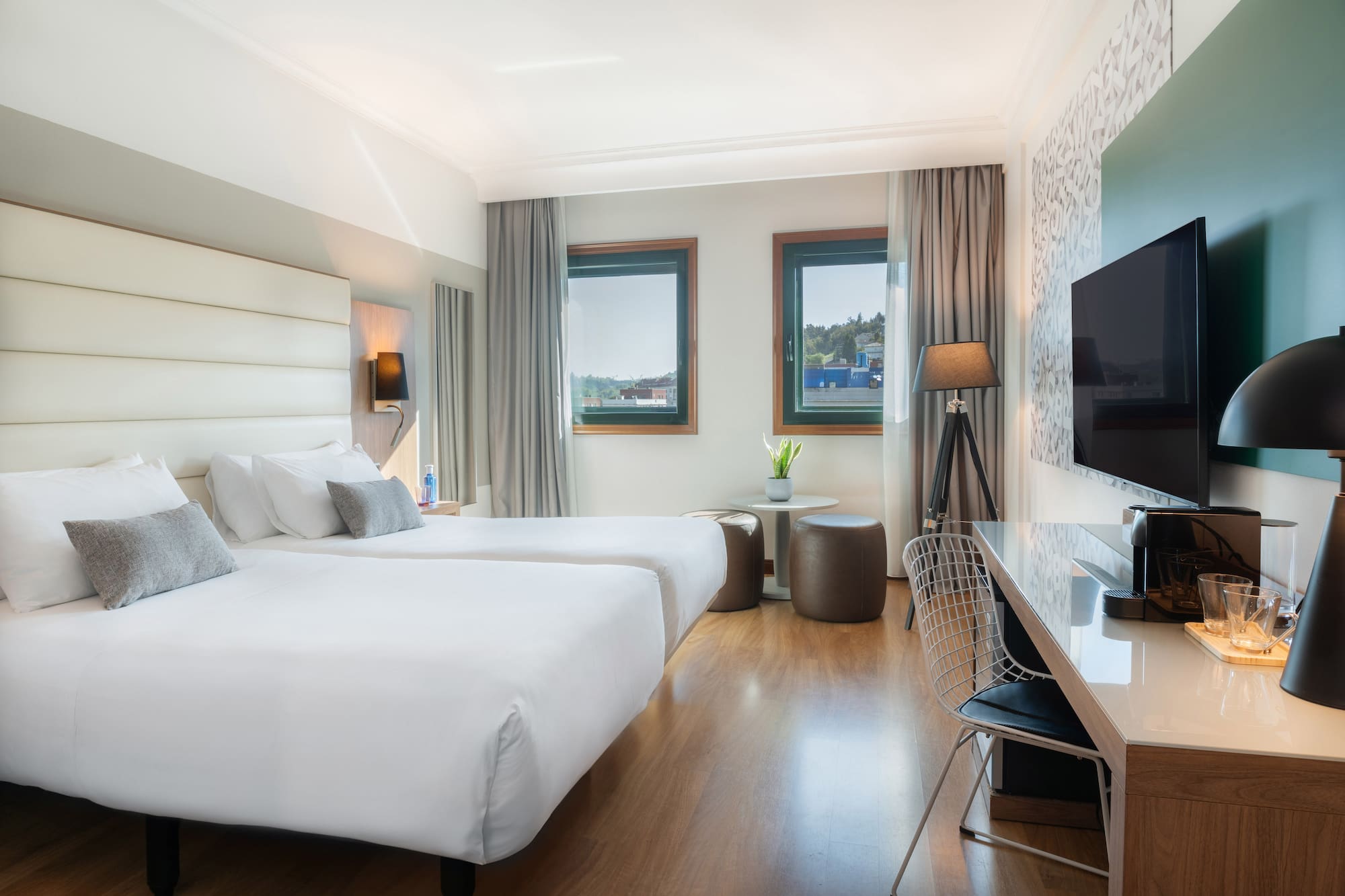 a room with two beds and a tv