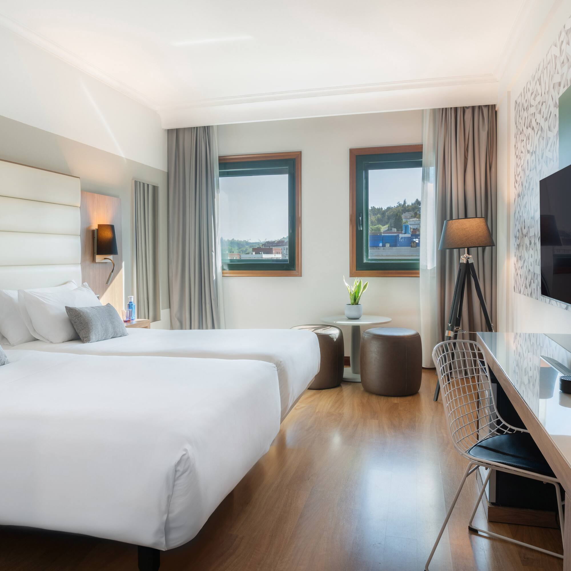 a room with two beds and a tv