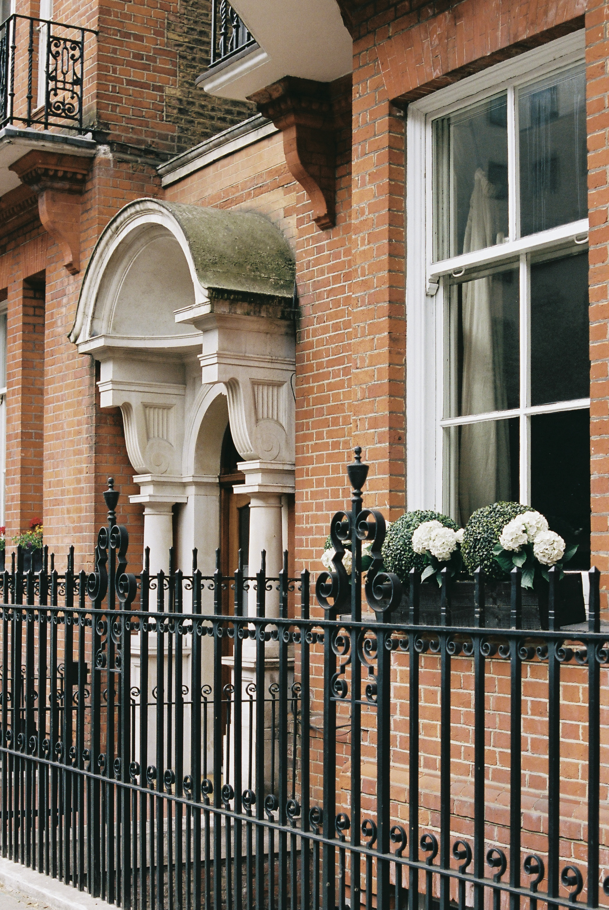a brick building with a fence
