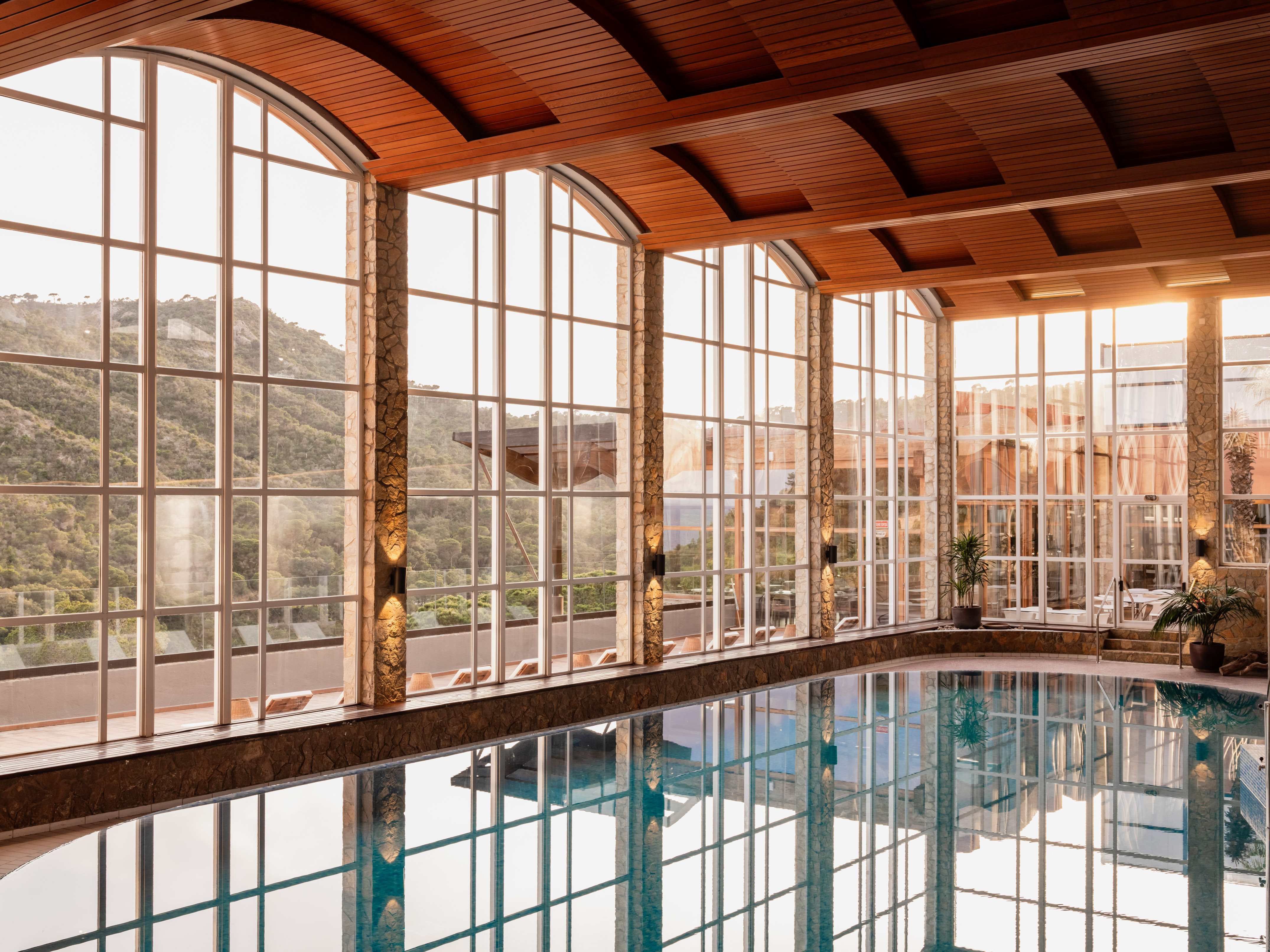 a indoor pool with large windows