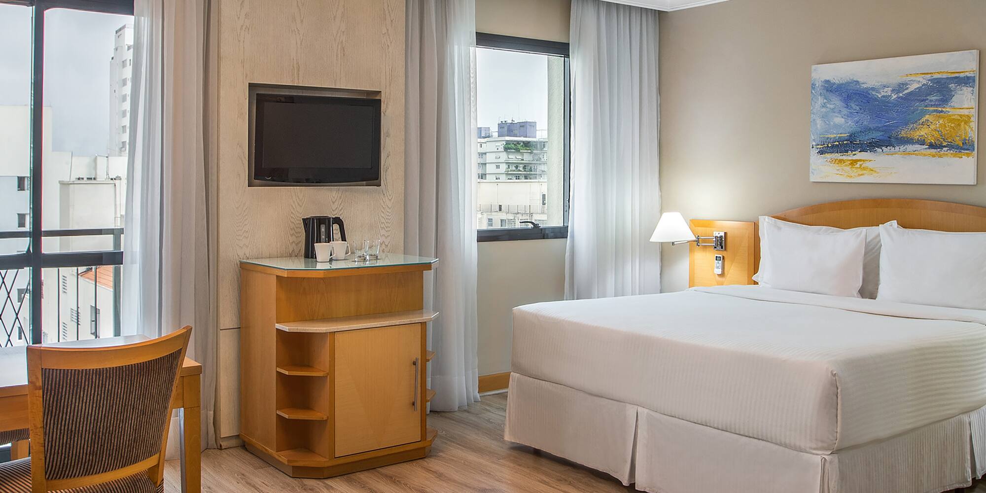 a room with a bed and a television