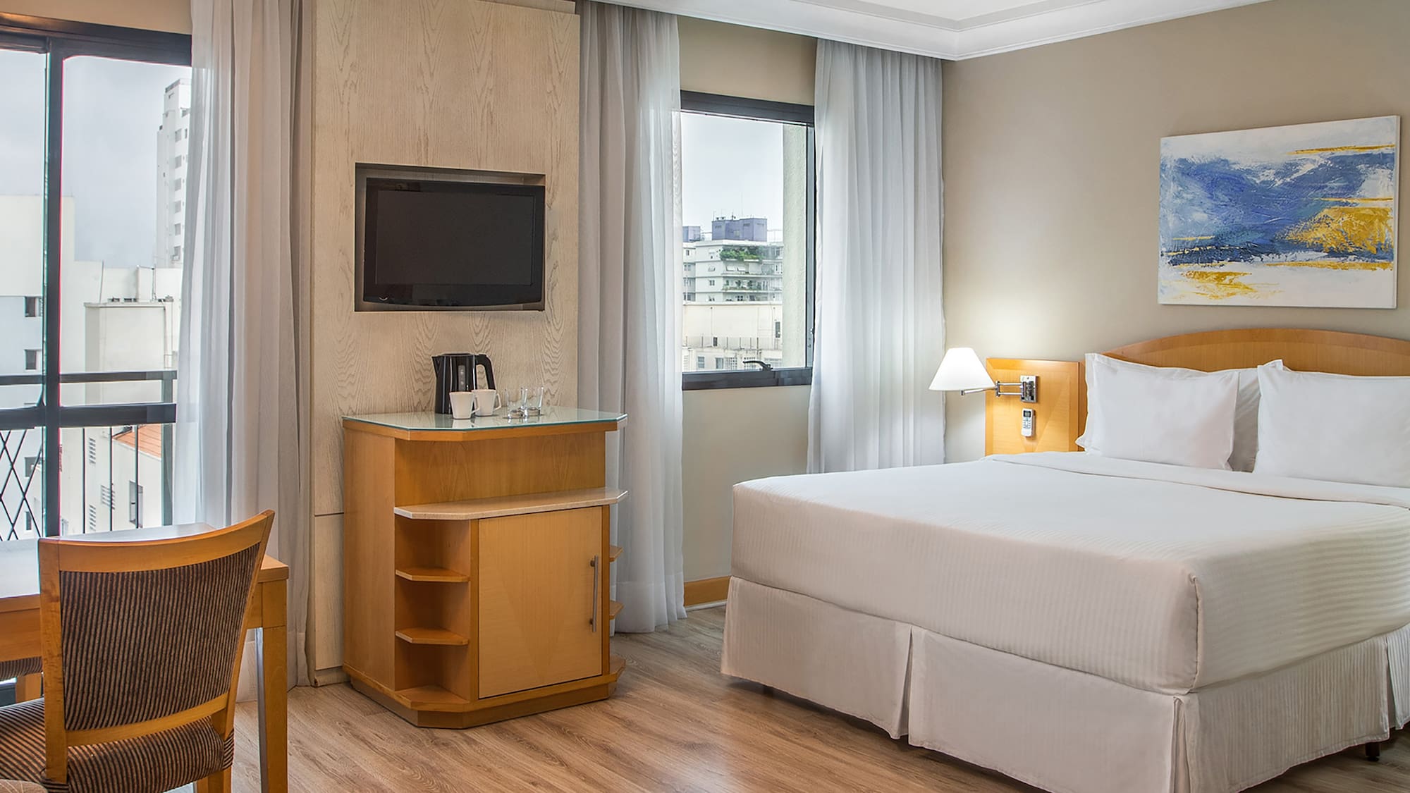 a room with a bed and a television