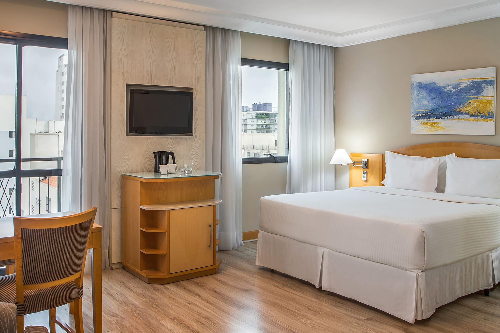 a room with a bed and a television