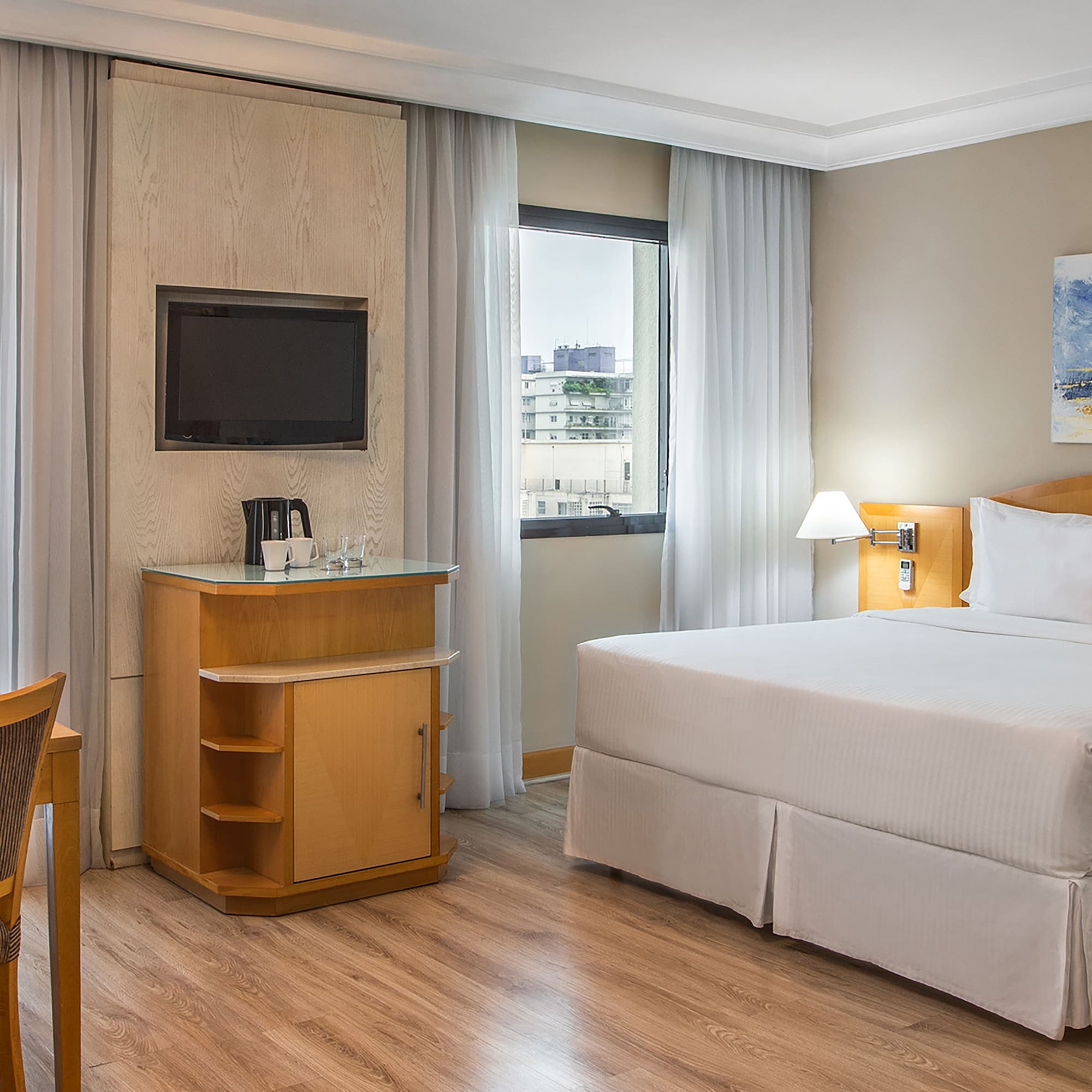 a room with a bed and a television