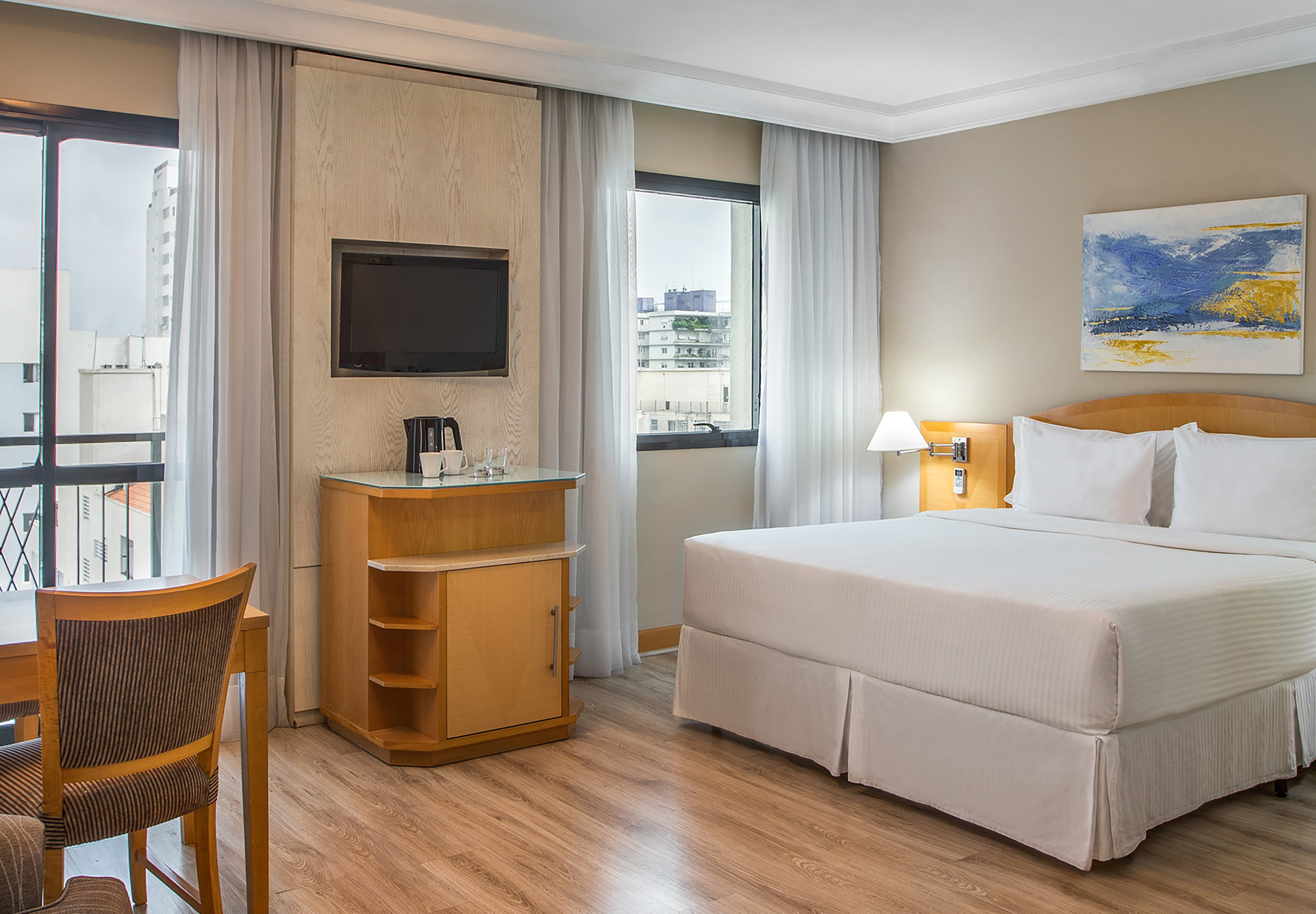 a room with a bed and a television