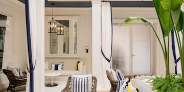 a room with a couch and chairs