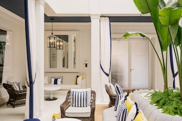 a room with a couch and chairs