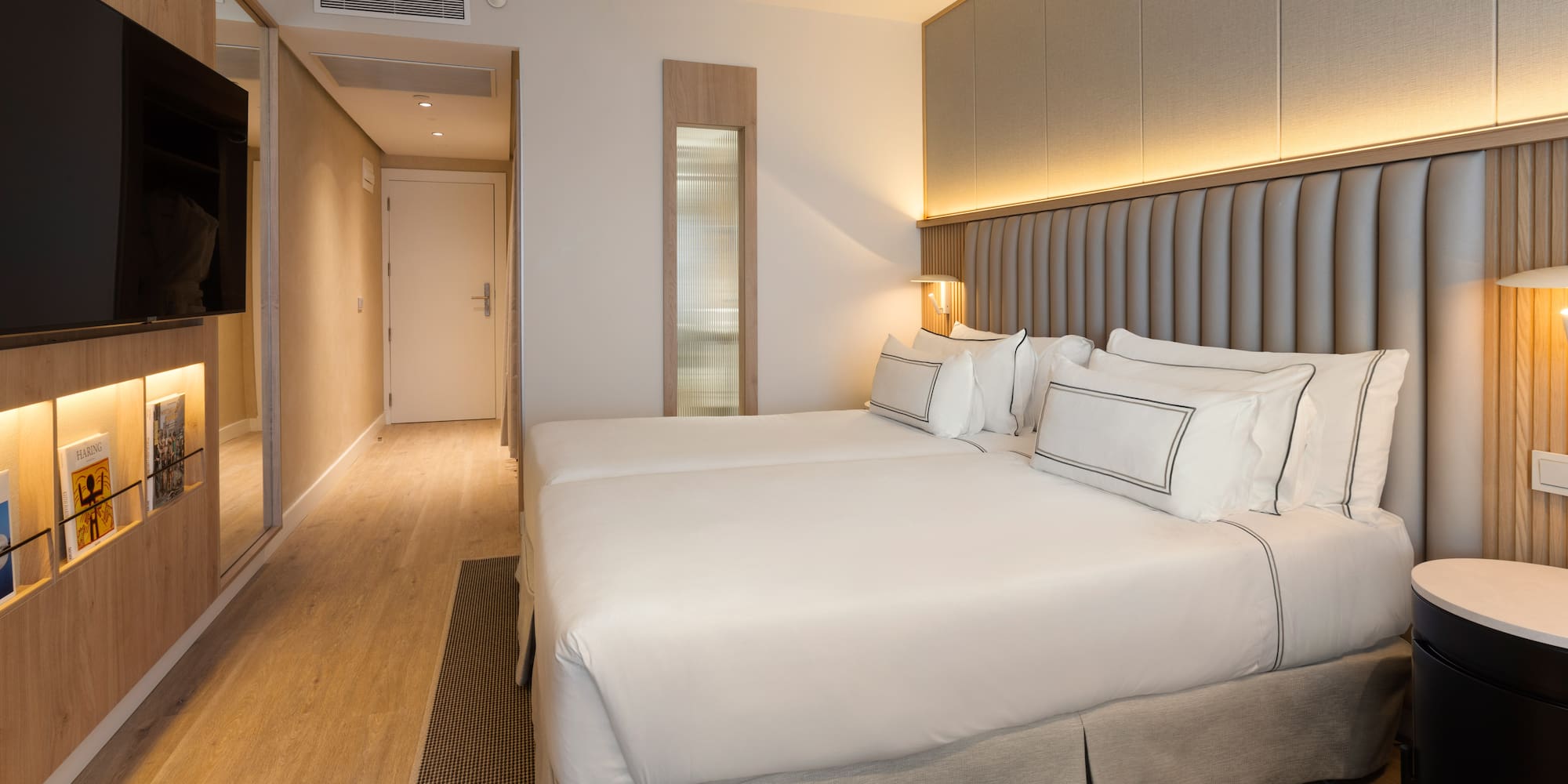 a room with two beds and a ceiling fan