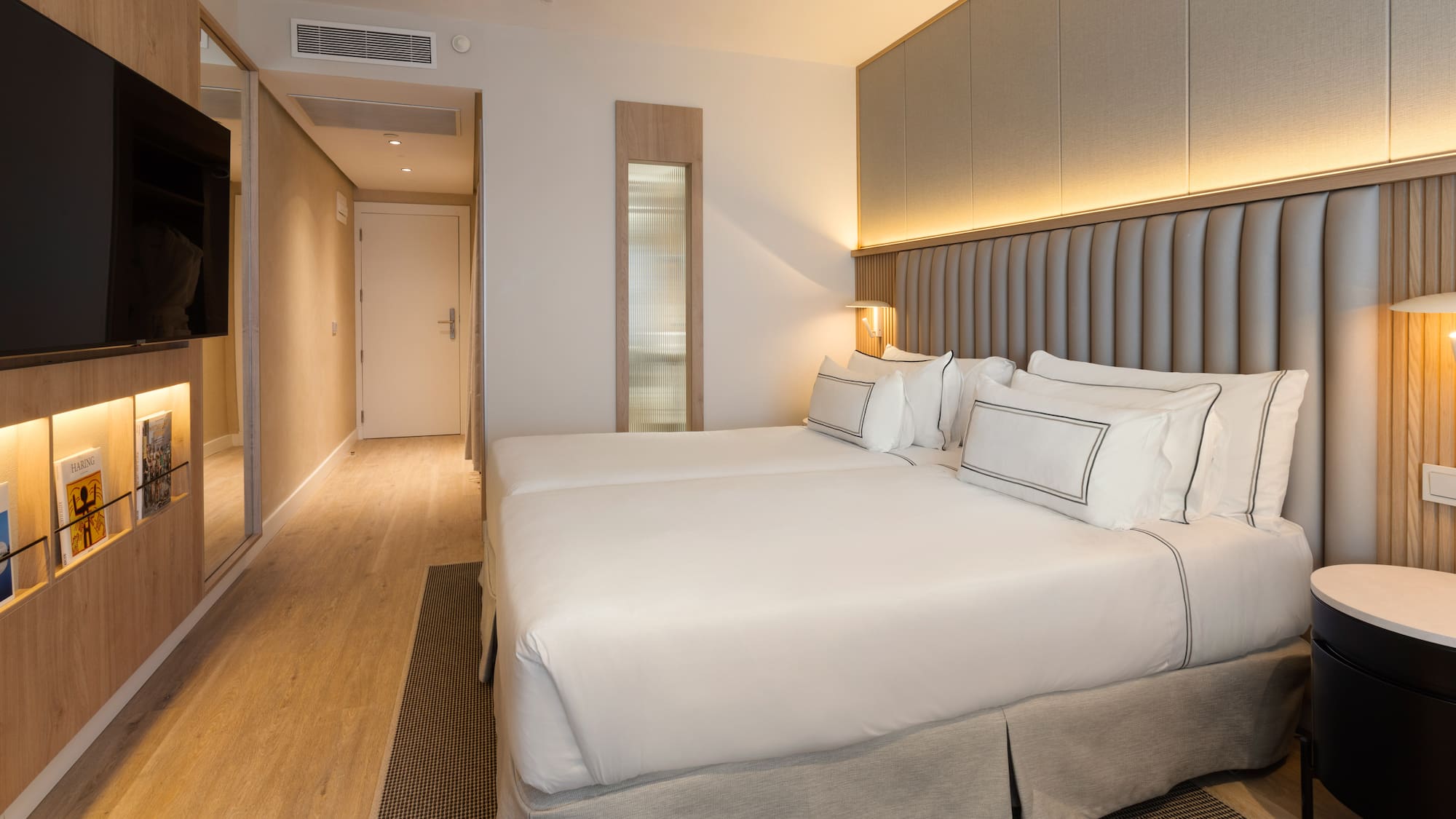 a room with two beds and a ceiling fan