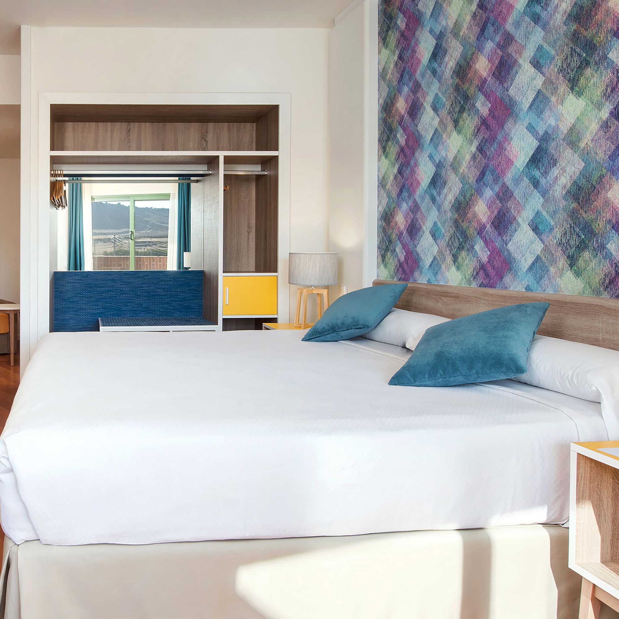 a bed with pillows in a room