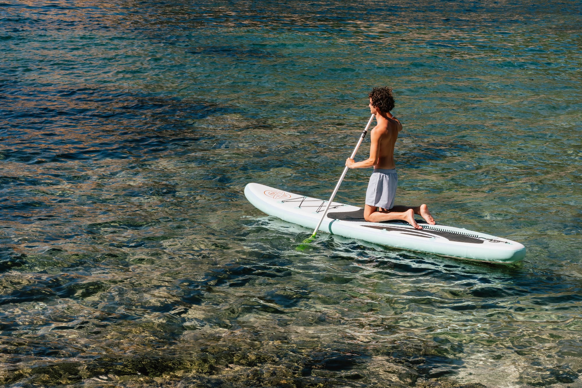 a man on a paddle board in the water