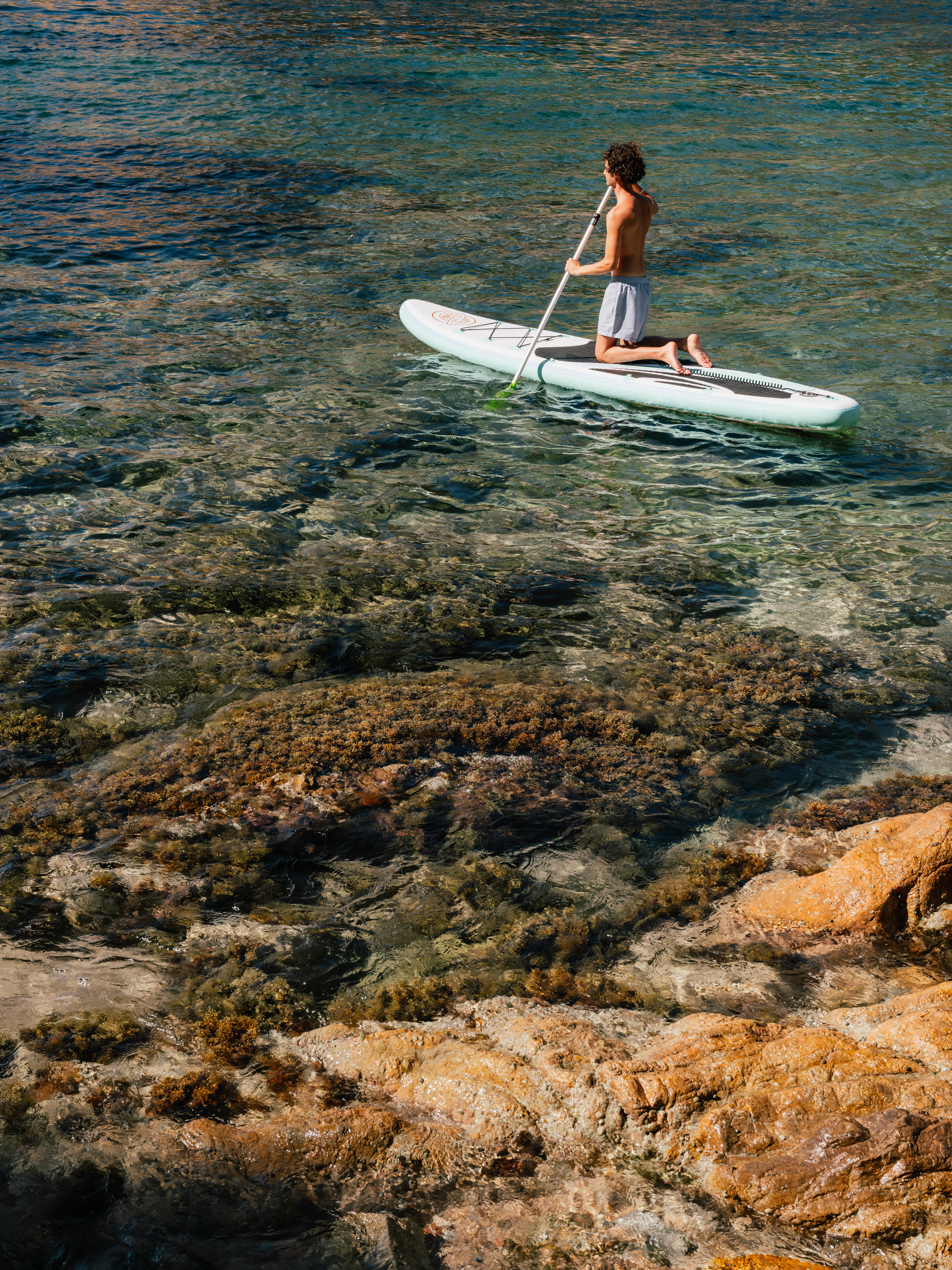 a man on a paddle board in the water