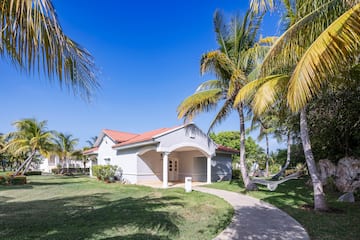 a white house with palm trees