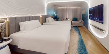 a room with two beds and a tv