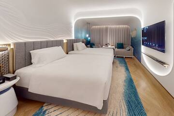 a room with two beds and a tv