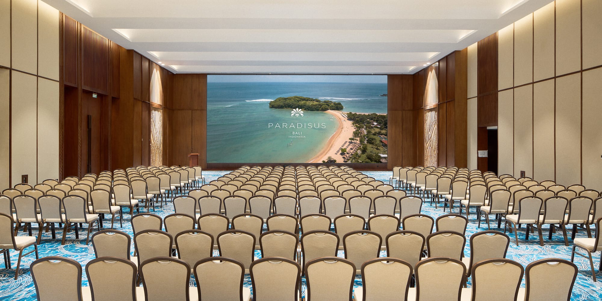 a large room with chairs and a screen