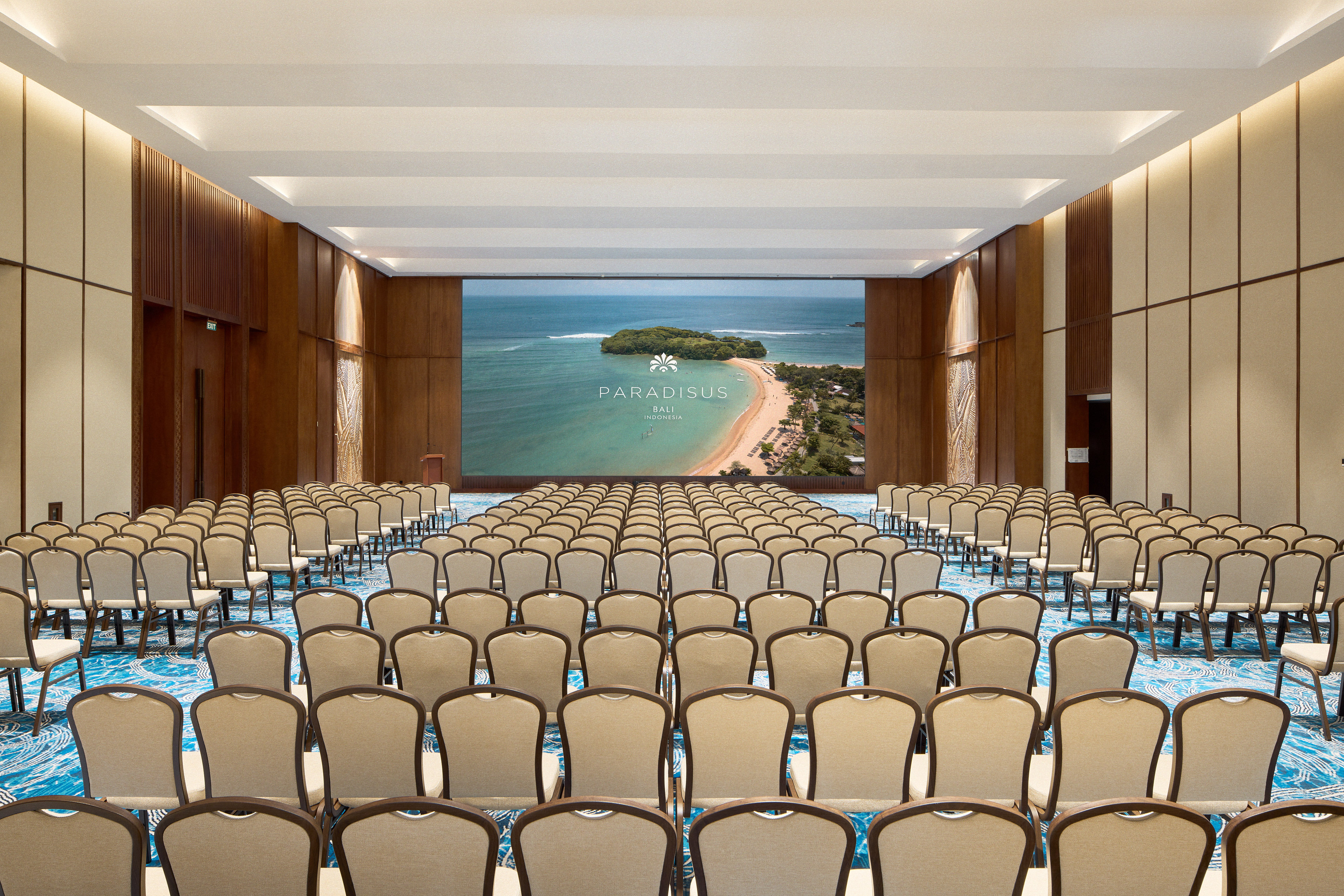 a large room with chairs and a screen