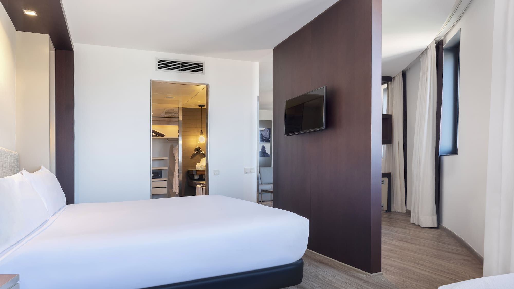 a room with a bed and a tv