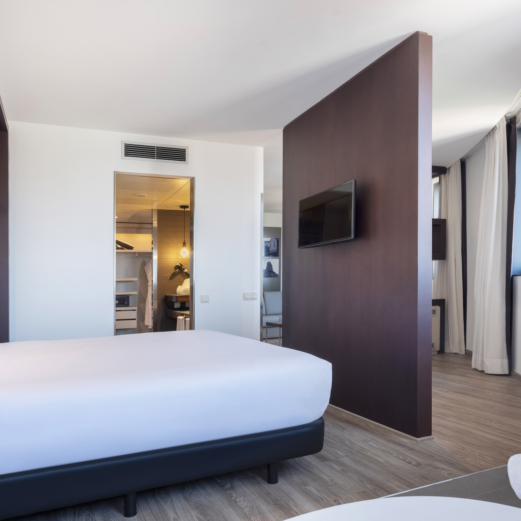 a room with a bed and a tv