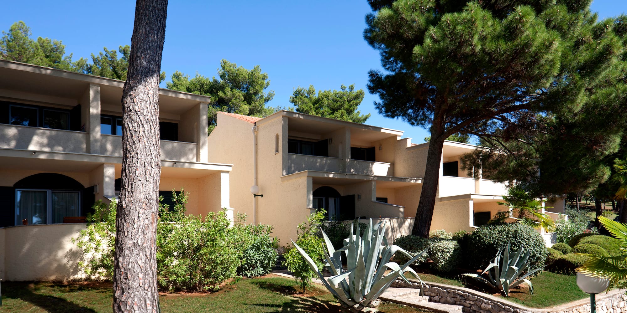 a building with trees and bushes