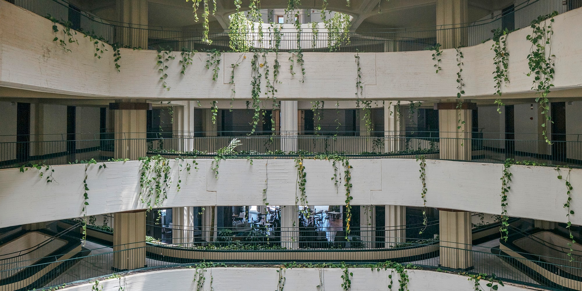 a building with many floors and a garden