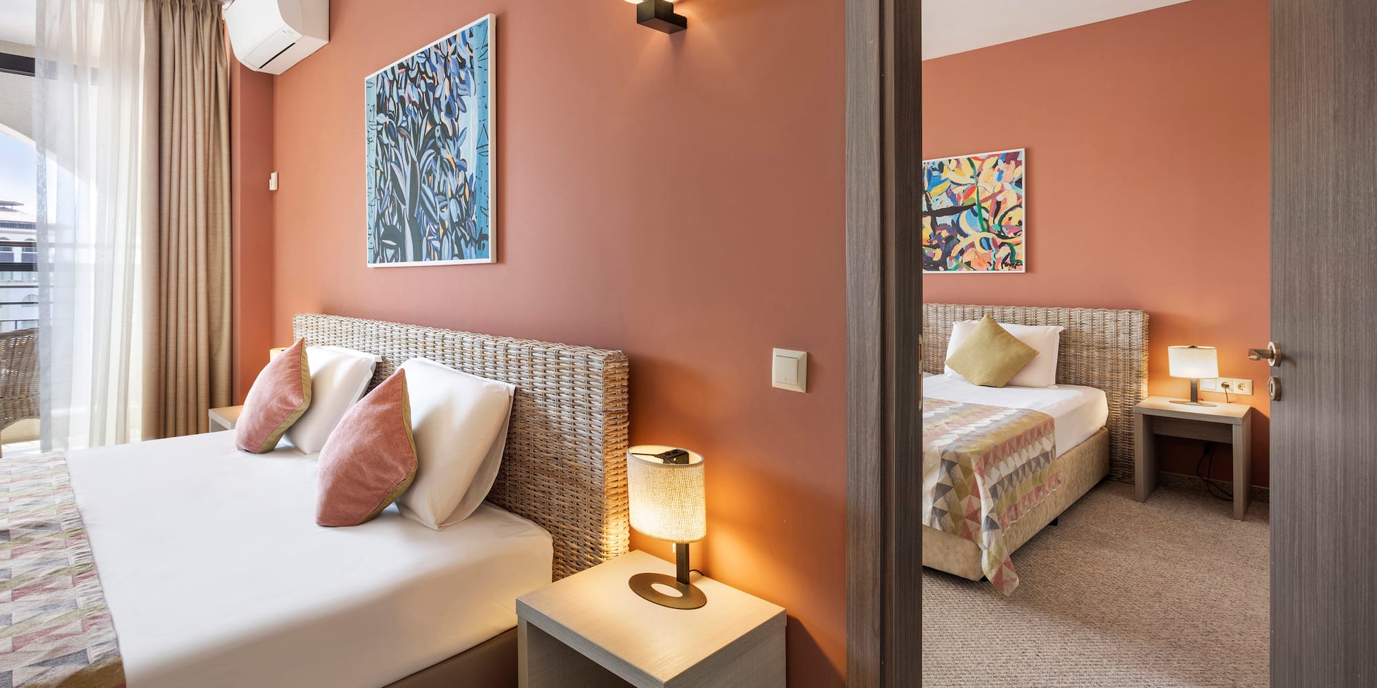 a bedroom with two beds and a couple of lamps