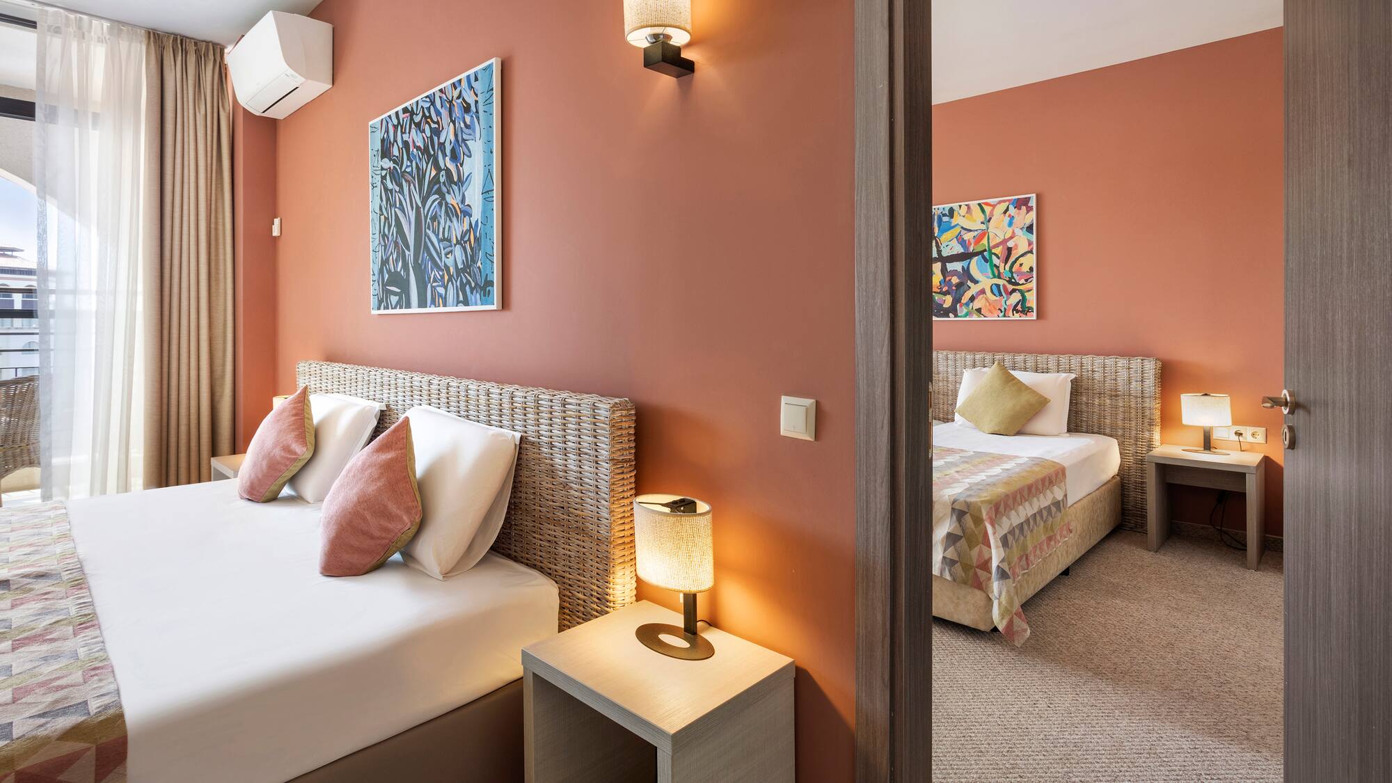 a bedroom with two beds and a couple of lamps