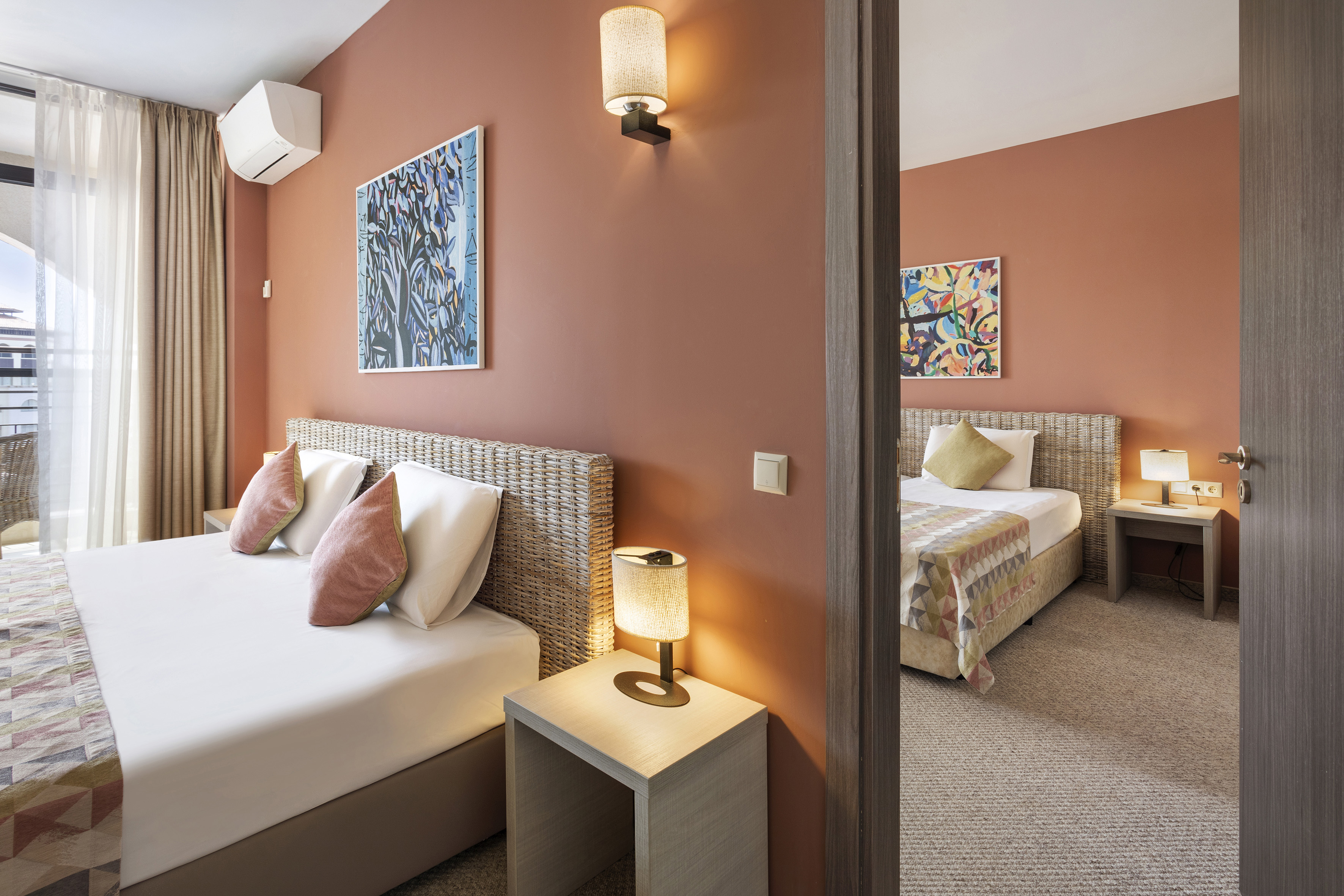 a bedroom with two beds and a couple of lamps