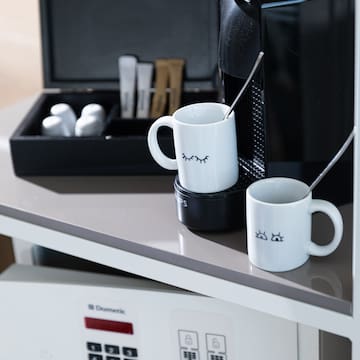 a coffee machine and mugs on a table