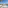 Luxury resort pool with palm trees, chaise lounges, and white canopy daybed.
