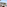 Luxury balcony with outdoor lounge furniture, ocean view, and tropical trees.