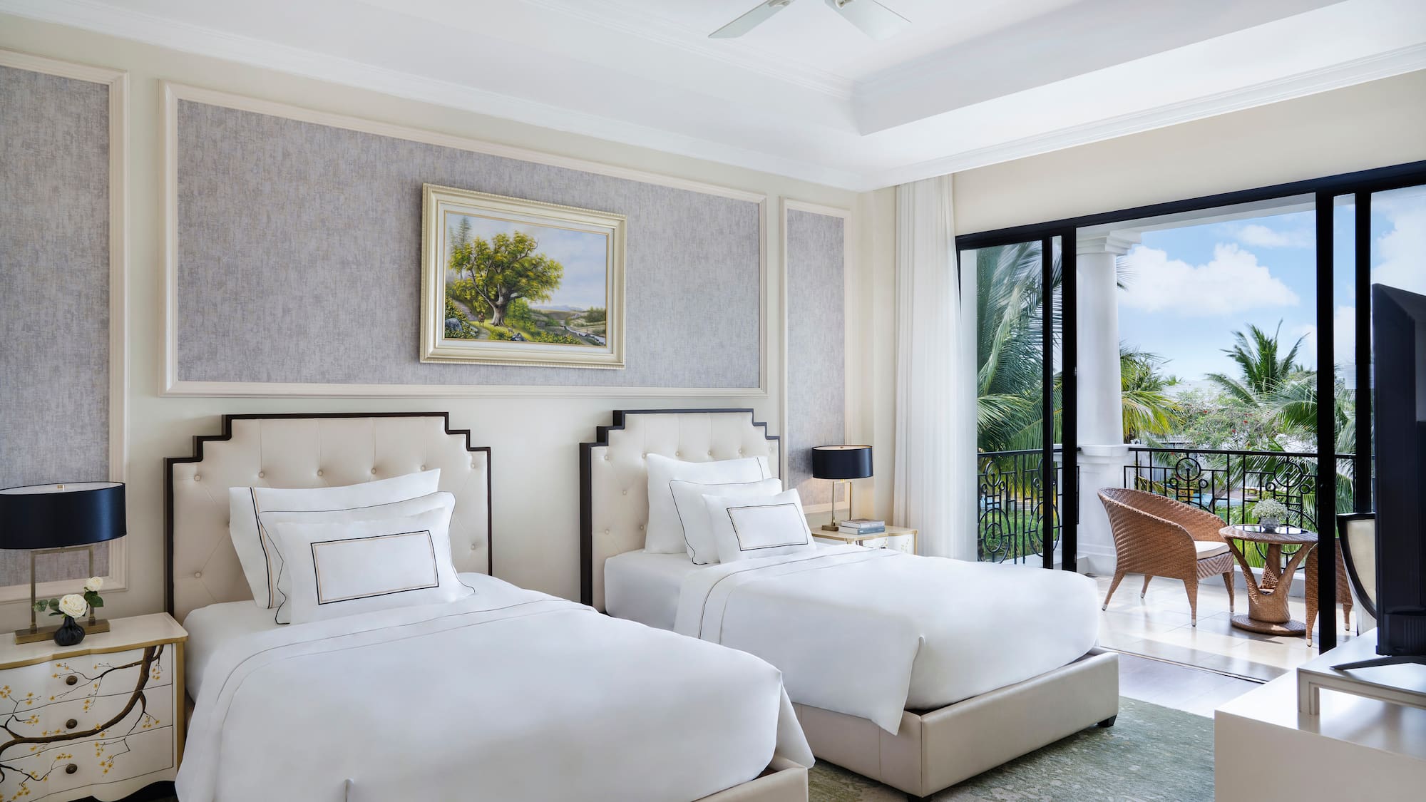 a room with two beds and a balcony