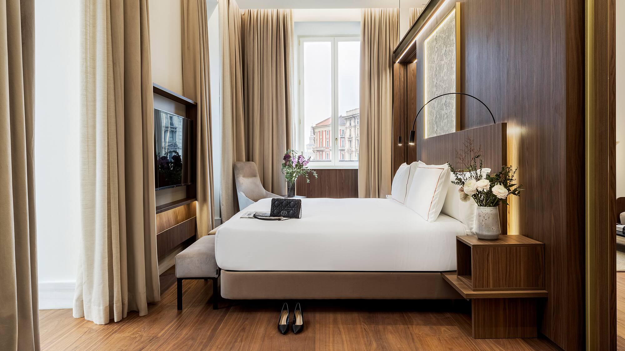 a bedroom with a bed and a tv