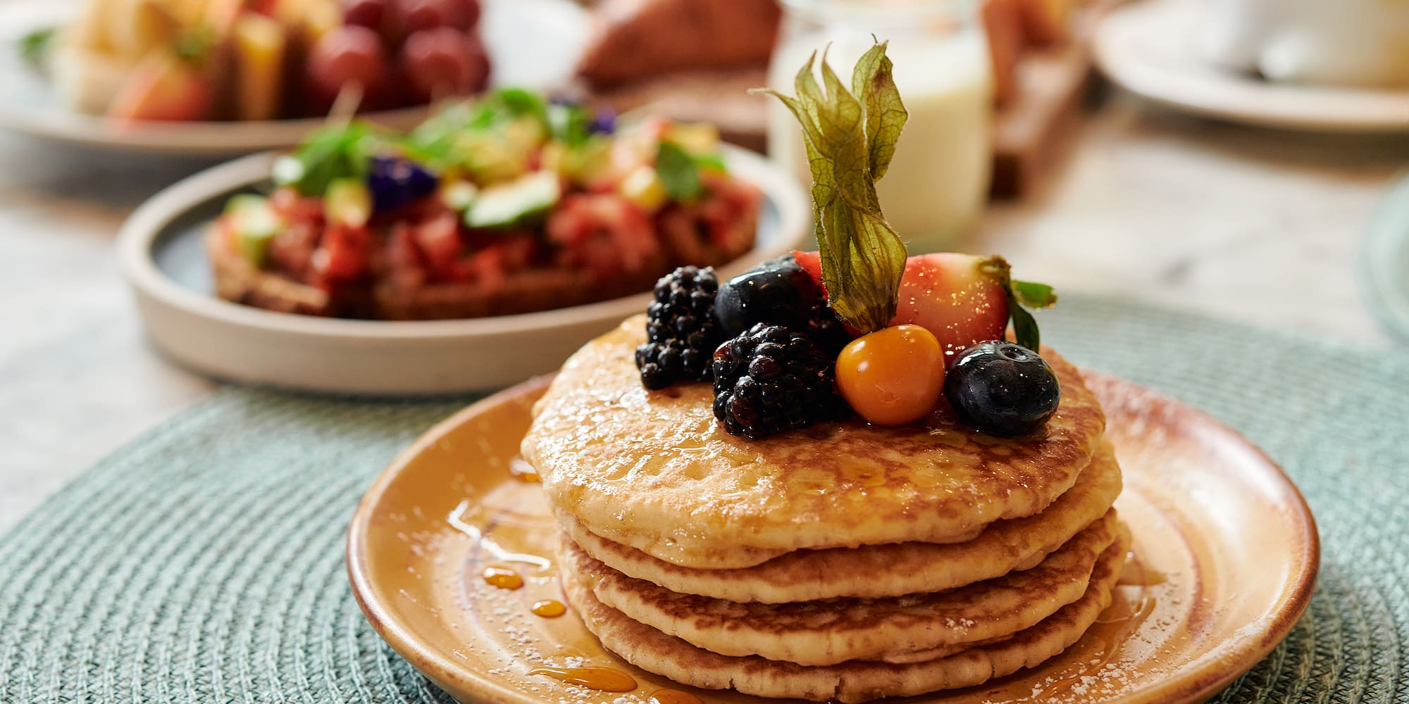 a stack of pancakes with berries on top