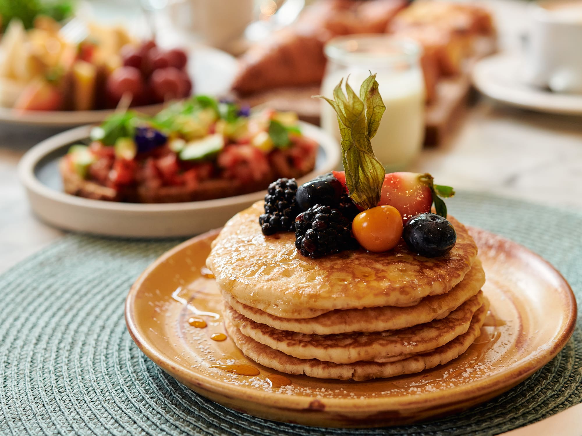 a stack of pancakes with berries on top