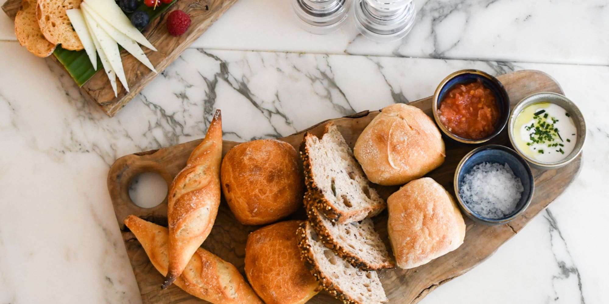 a plate of bread and cheese on a marble table