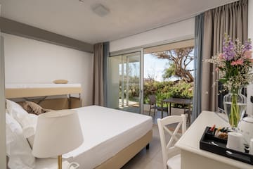 a room with a bed and a table and chairs