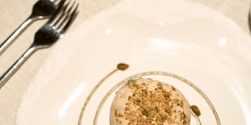 a plate with a pastry on it and a cup of tea