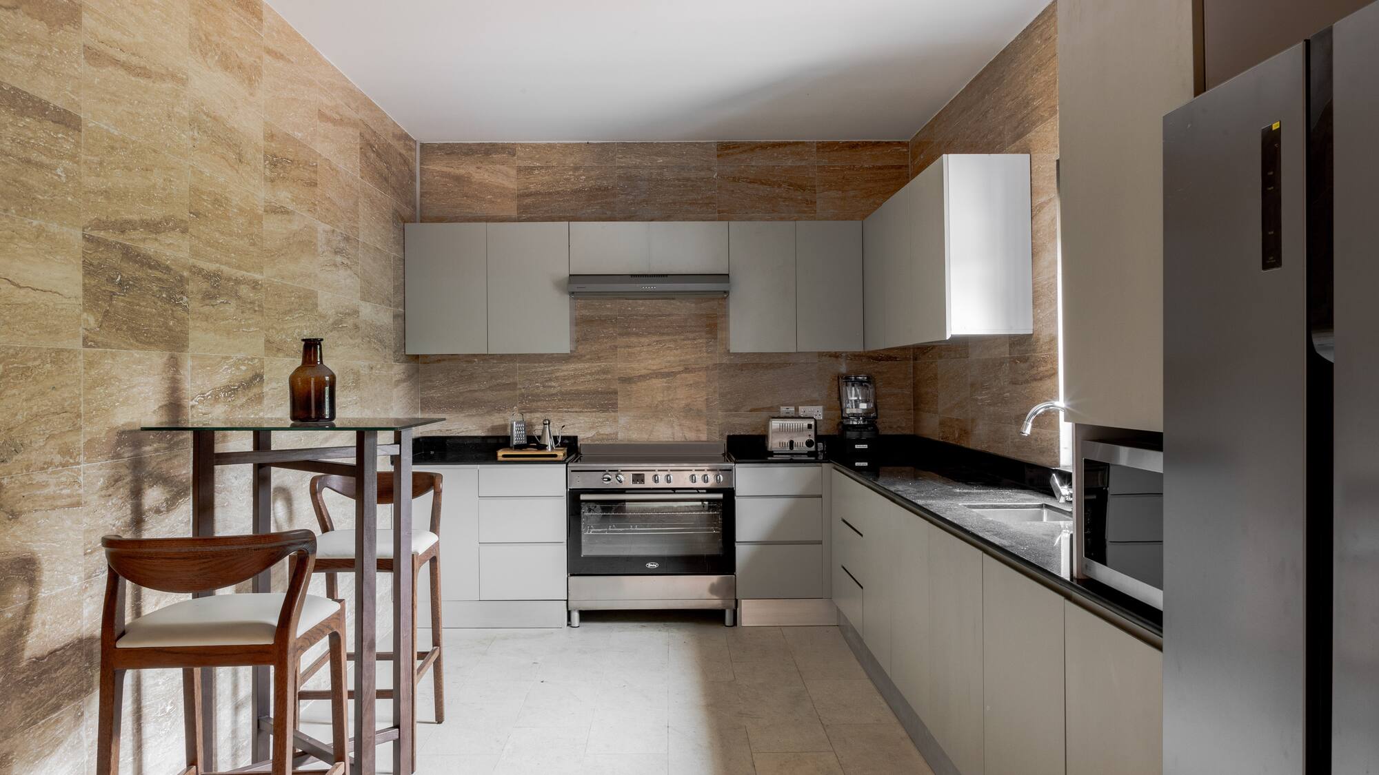 a kitchen with white cabinets and a table