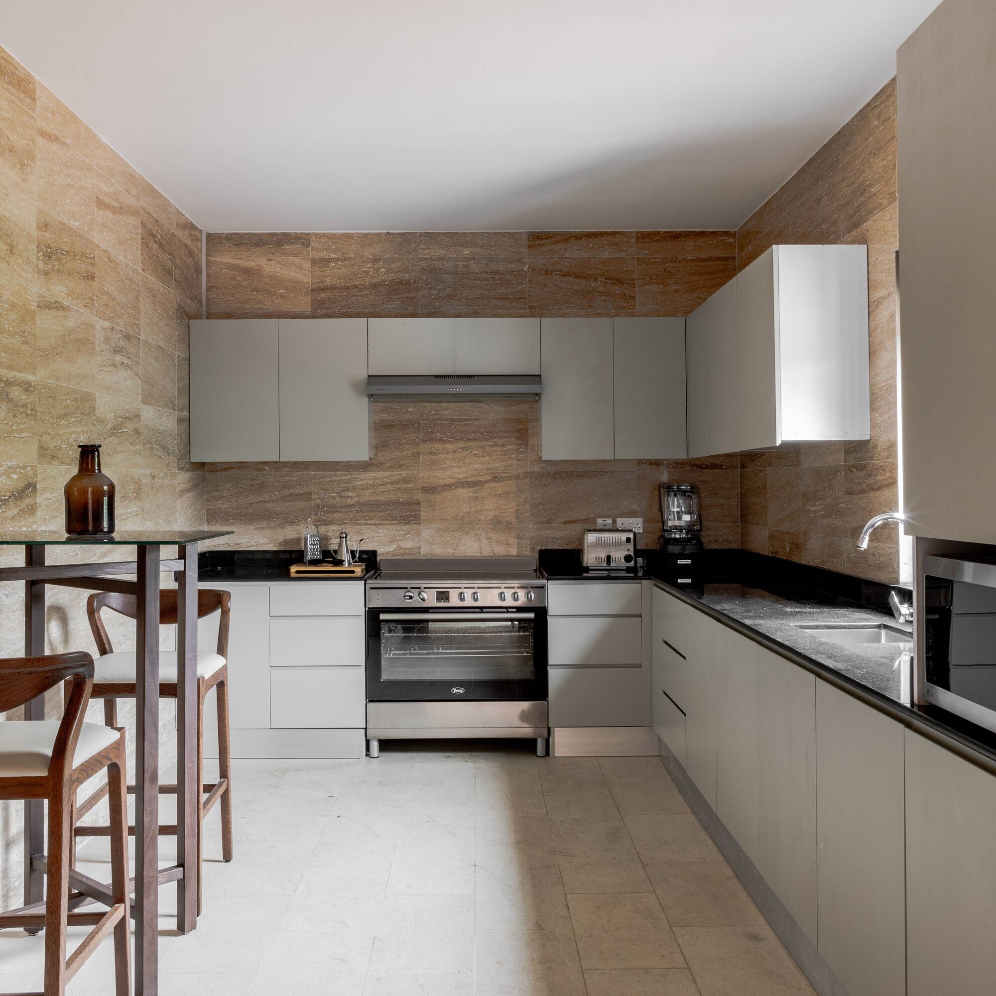 a kitchen with white cabinets and a table