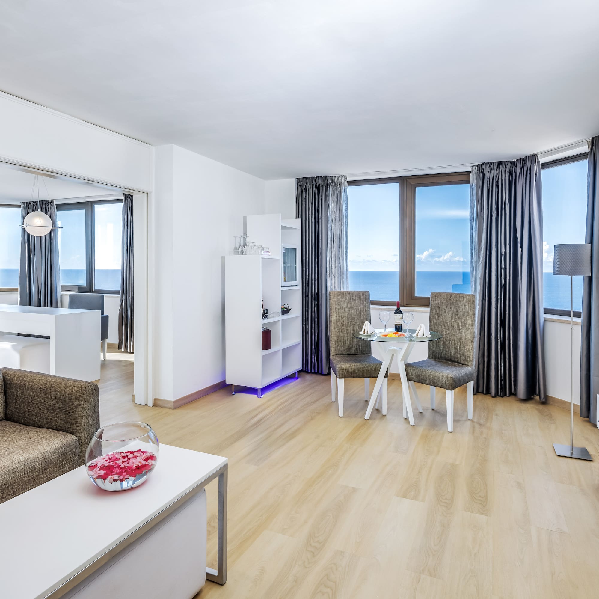 a living room with a table and chairs