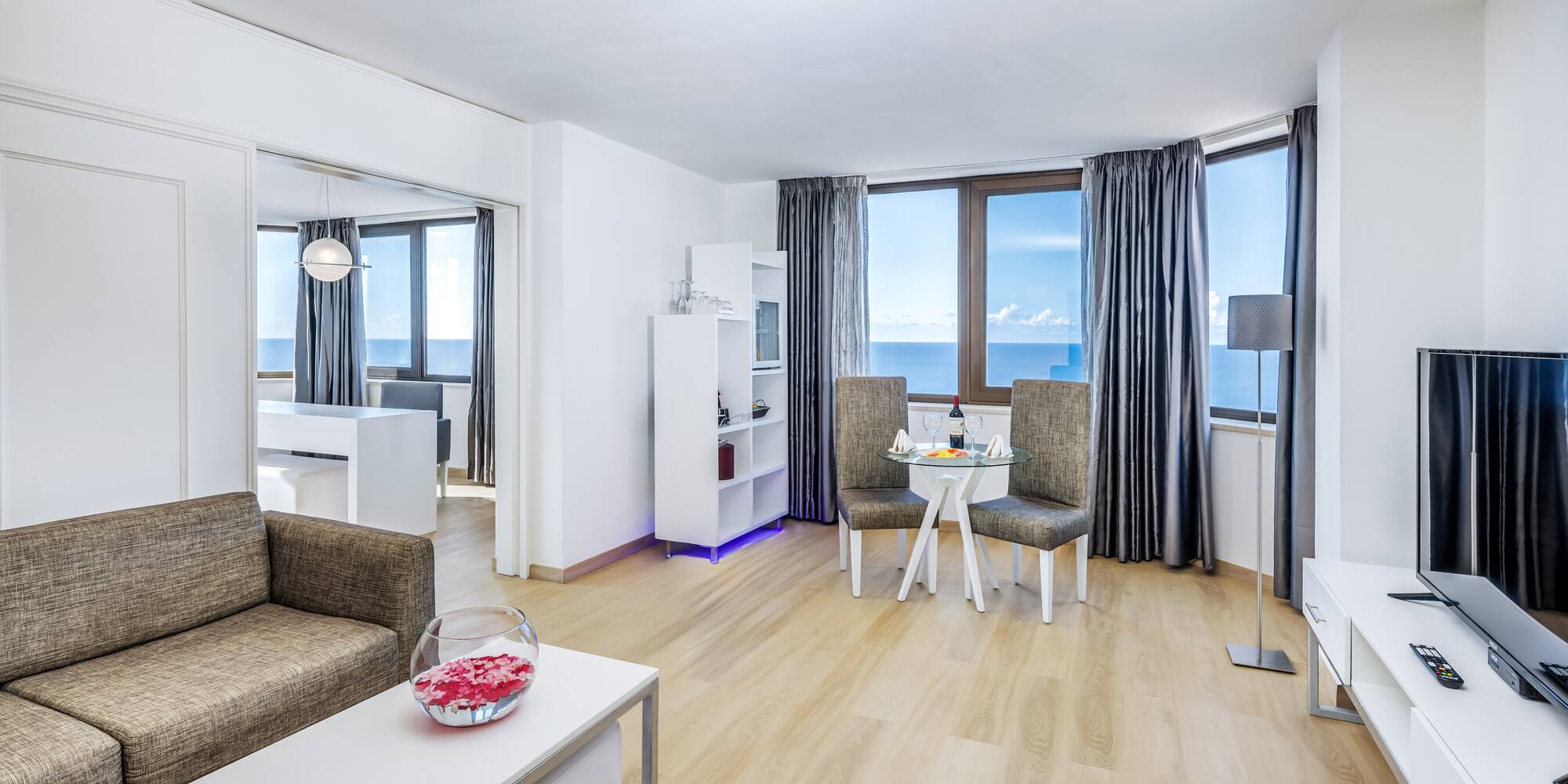 a living room with a table and chairs