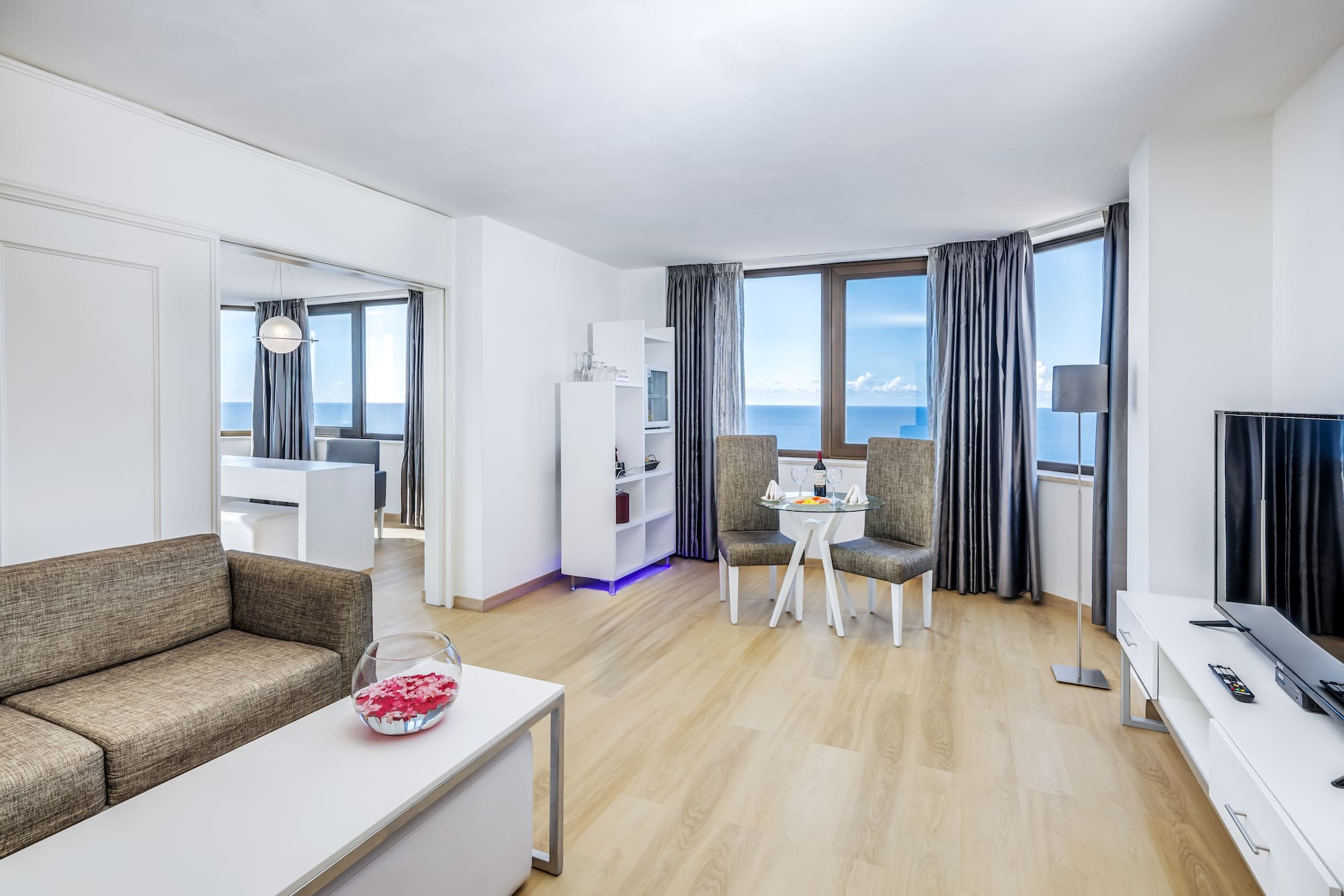 a living room with a table and chairs